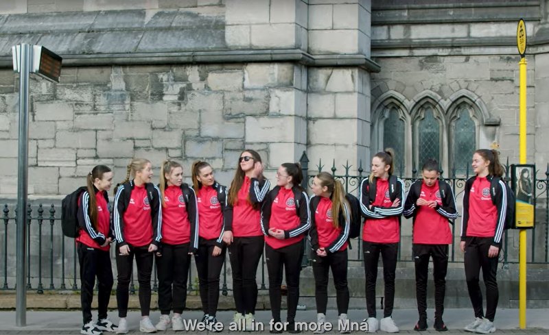 Image of female bohs team waiting for the bus