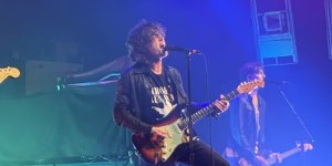 Image of male musician on stage with guitar, from the band Inhaler