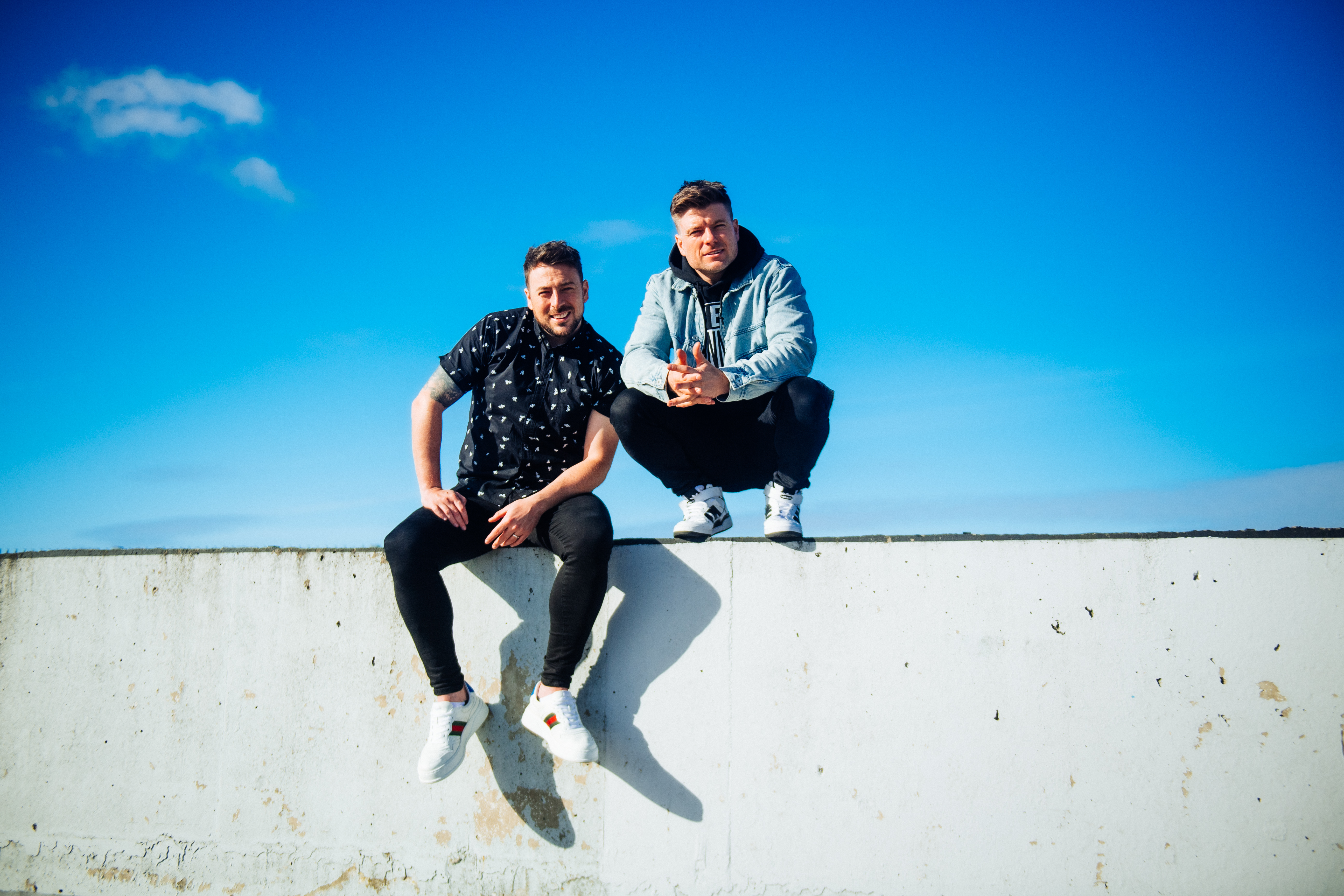 Image of the two Johnnies sitting on a wall