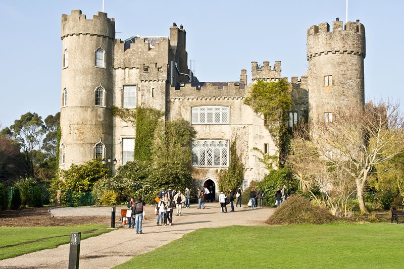 Scenic image of grass and historical Malahide castle