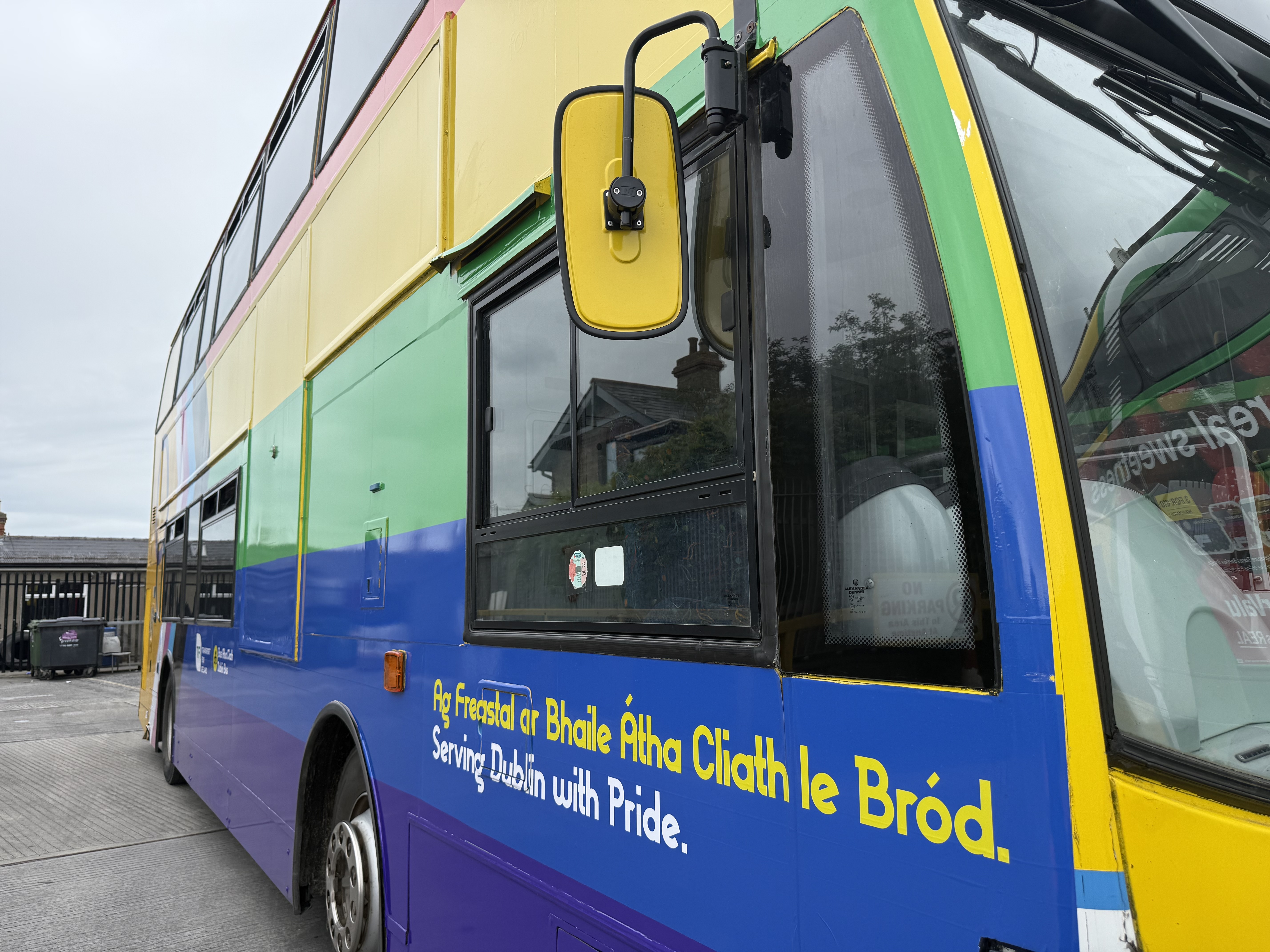 Front view of bus featuring drivers cab window and wing mirror