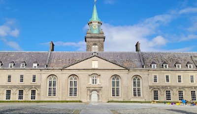 Low image of the full, grand building of museum with blue sky