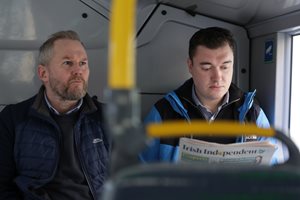 Two customers sitting at the back of the bus
