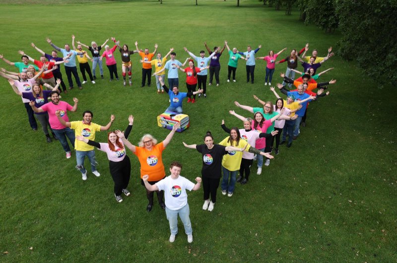 Heart shape made by people in pride tshirts