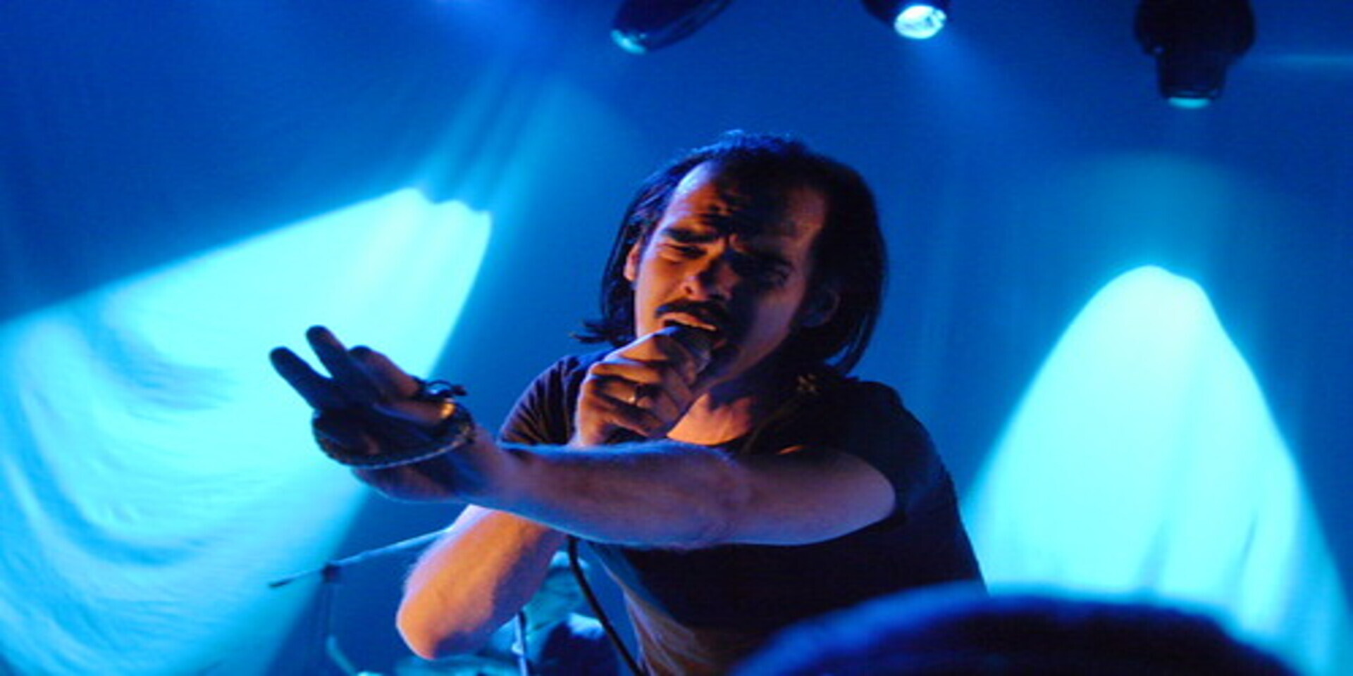 Image of Nick Cave and the Bad Seeds on stage performing