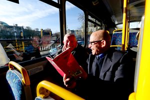 Roger and customer sitting on bus