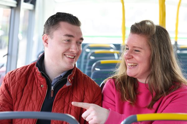 Two customers chatting on bus 