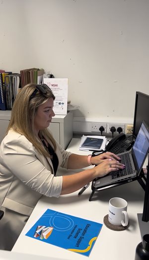 Image of Claire Byrne, Modern Workplace Executive typing on laptop at her desk