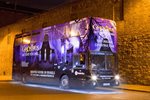 Image of DoDublin's purple ghostbus at night time with lights on