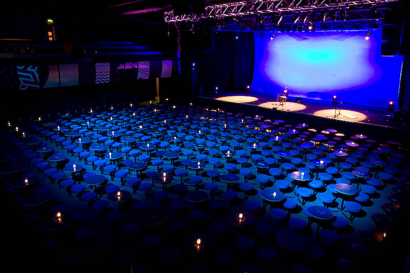 Inside Vicar Street venue, dark lighting black and blue and stage lit up