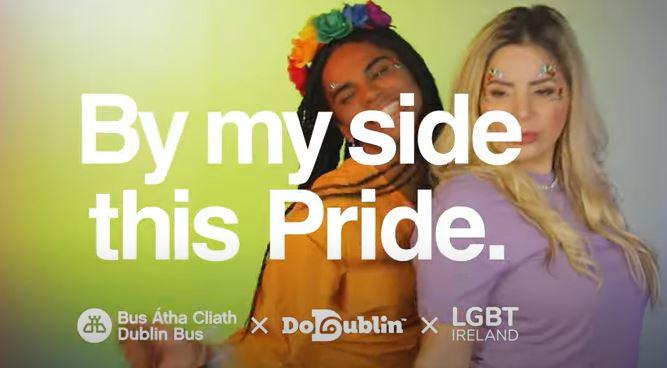 YouTube Image of two women with text that reads By my side this pride