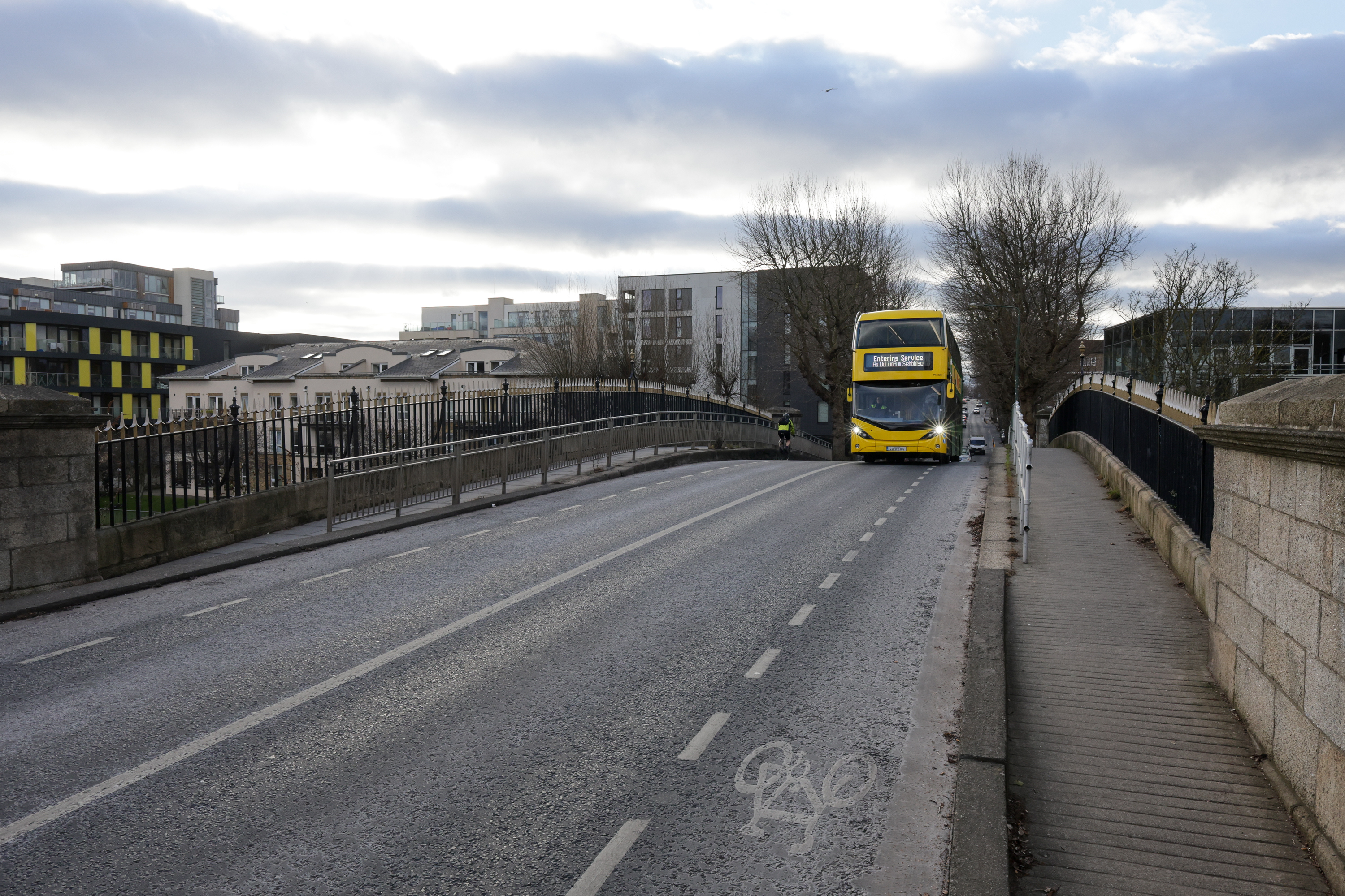 Shot of oncoming bus crossing bridge in Dublin