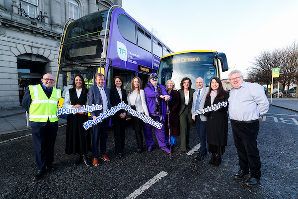 Image of purple bus and staff celebrating International-Day-of-Persons-with-Disabilities-2025